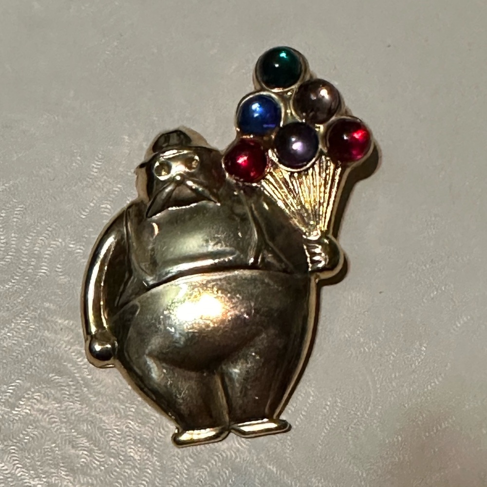 Vintage whimsical man with balloons pin.